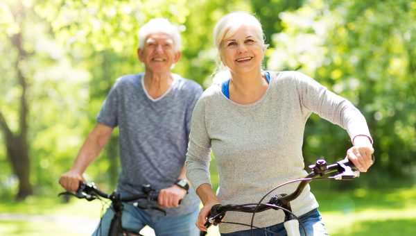 Smiling mature couple on their bicycles