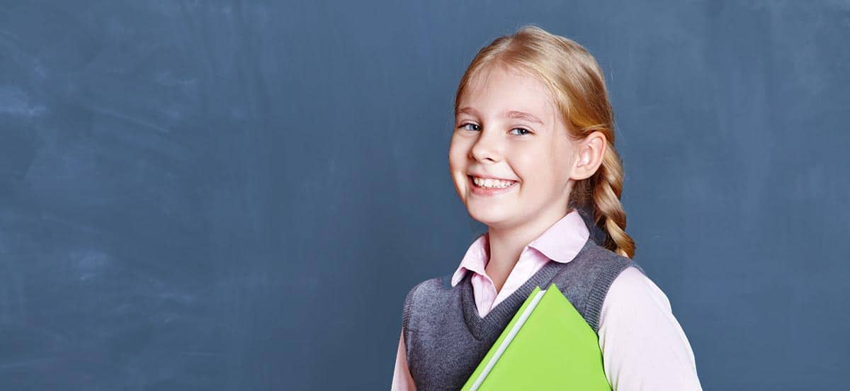 Schoolgirl_smiling-blackboard