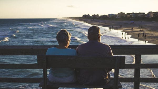 Old couple looking at surf