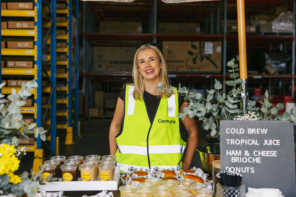 woman smiling with drinks in front of her